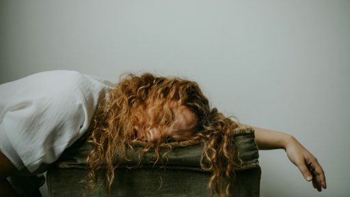 woman in white shirt lying on black textile