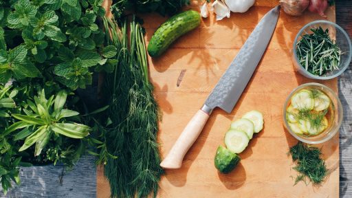 sliced cucumber and green vegetable on brown wooden chopping board