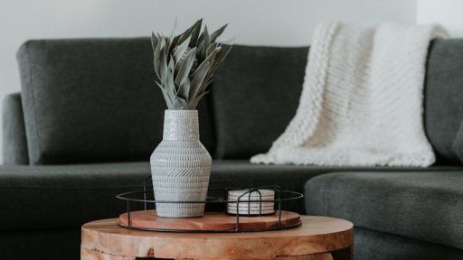white and black ceramic mug on brown wooden table