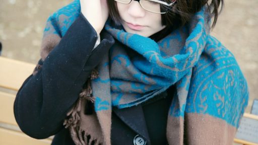 woman sitting on bench reading book