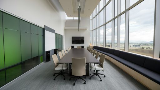 rectangular brown wooden table with chair lot inside building