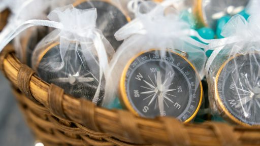 Compasses are gifts in white mesh bags.