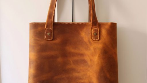 brown leather handbag on white table