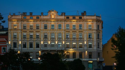 Elegant historic building lit up in the evening sky, showcasing classic architecture.