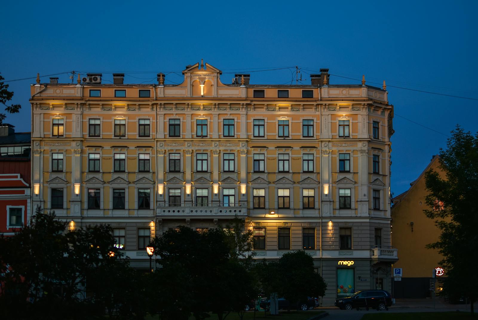 Elegant historic building lit up in the evening sky, showcasing classic architecture.