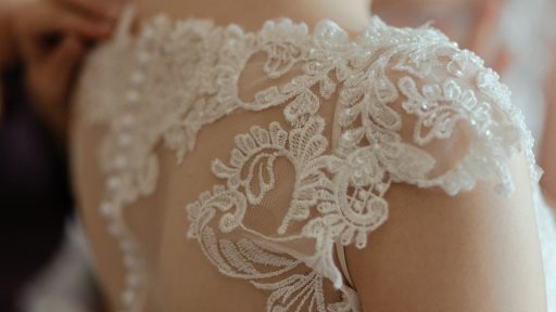 woman wearing white sheer lace wedding gown