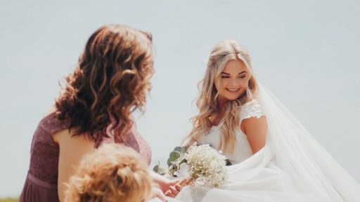 a woman in a wedding dress holding a bouquet of flowers