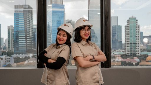 Two women in hard hats and uniforms