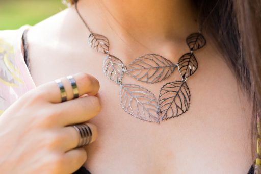Plat neergelegd overzicht van goedkope accessoires zoals riemen, ringen en haarclips op een lichte ondergrond